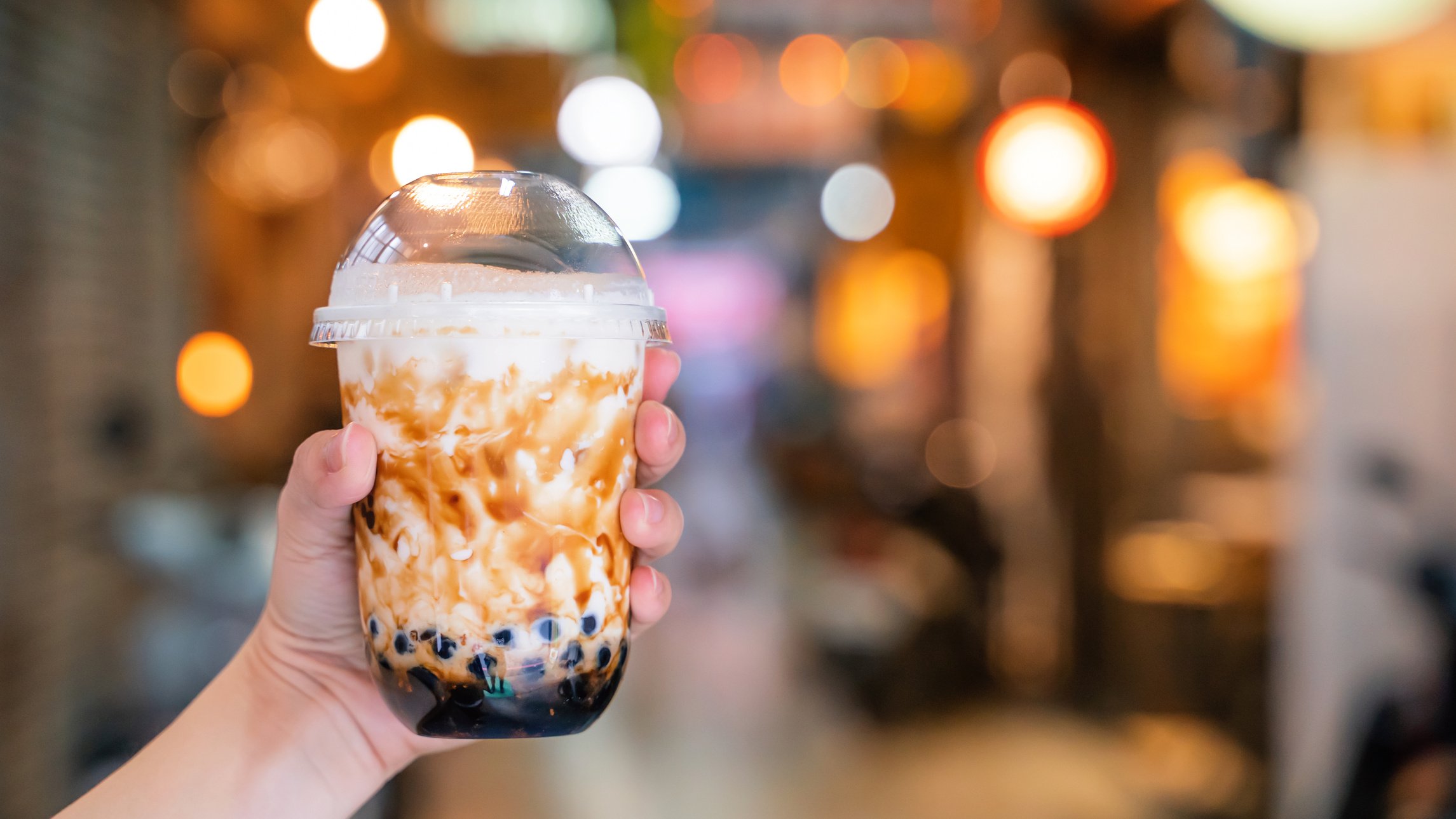 Young Woman Holding Brown Sugar Milk Tea